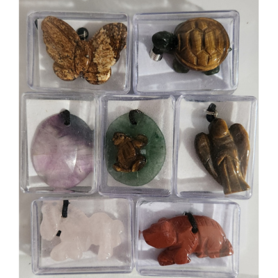 Assorted carved gemstone pendant necklaces including butterfly, turtle, worry, angel, and animal designs