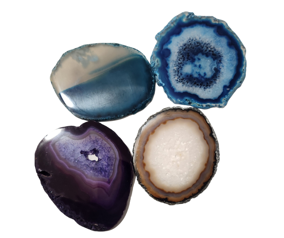 Four thin agate slices with blue, teal, purple, and natural banding on a white background