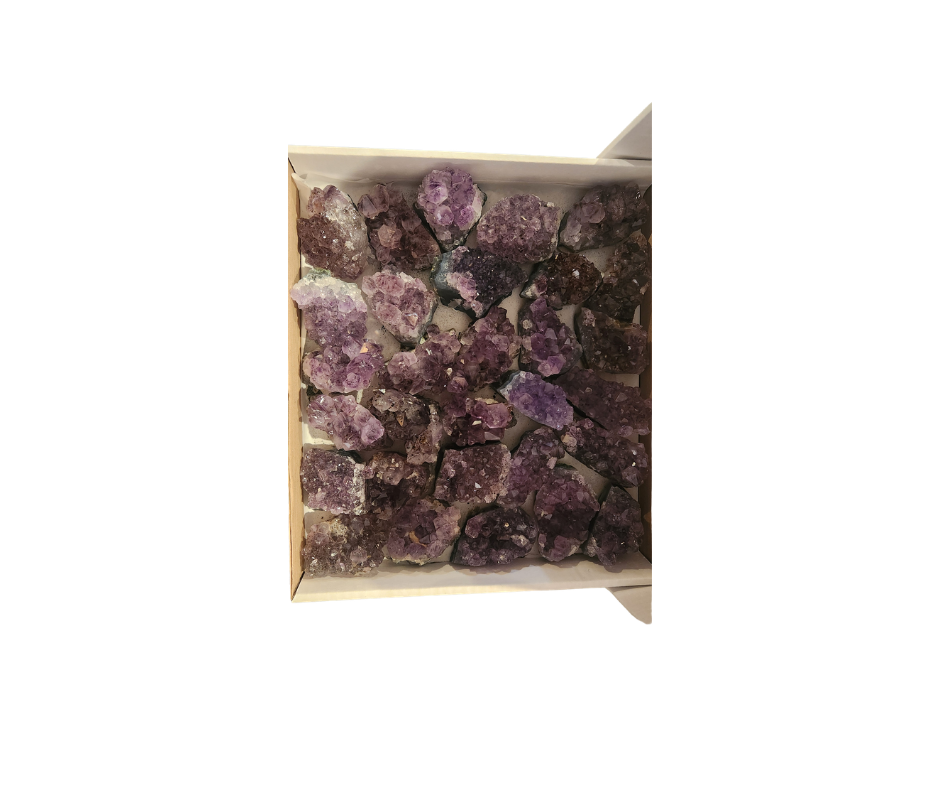 Open box of B Grade amethyst clusters in lavender and purple tones