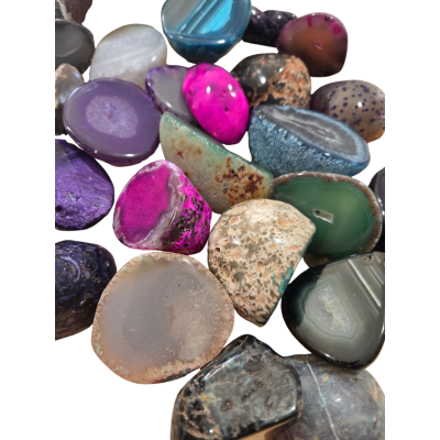 Assorted polished agate halves showing natural stone patterns and brightly colored pieces